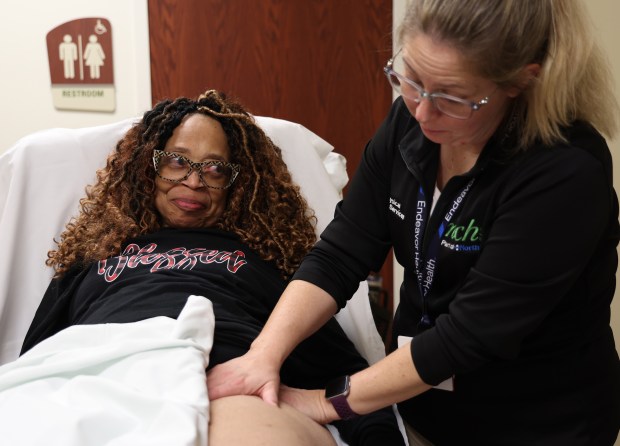 Pamela Harris, left, receives a lymph drainage massage from a trusted physical therapist, Amy Miller of Northwest Community Hospital Physical Rehabilitation Services in Rolling Meadows. Harris has filed suit against a doctor not connected with Endeavor Health Northwest Community Hospital, alleging that he touched her inappropriately. (Stacey Wescott/Chicago Tribune)