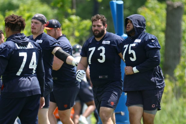 Chicago Bears offensive linemen Jake Curhan (73) and Larry Borom (75) work out Thursday, May 23, 2024, during OTAs at Halas Hall. (Brian Cassella/Chicago Tribune)