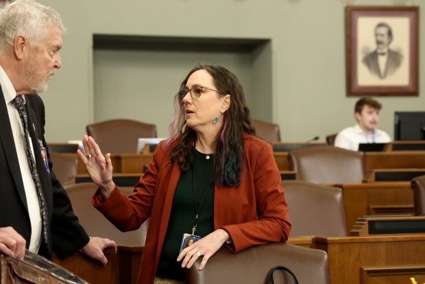 State Rep. Kelly Cassidy, right, chats with state Rep. Steve Reick before the start of a committee meeting in the state Capitol this month in Springfield. (Stacey Wescott/Chicago Tribune)