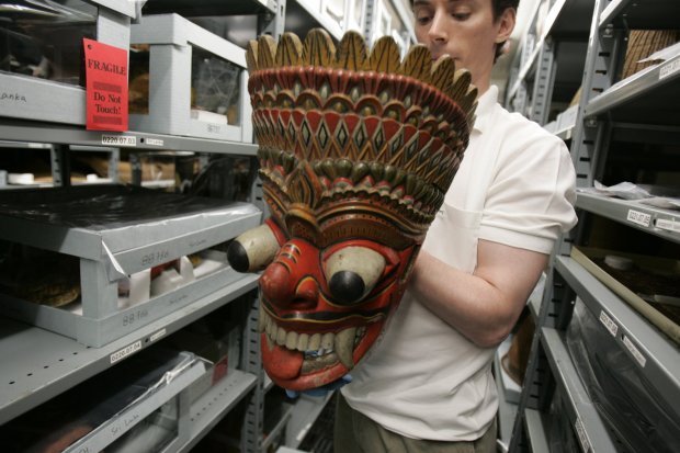 Christopher Philipp, collections manager of the Field Museum department of anthropology, holds a dancing mask from Sri Lanka, one of the 20,000 exhibit pieces from the 1893 World's Fair being readied to be shown online in 2005. (Scott Strazzante/Chicago Tribune)