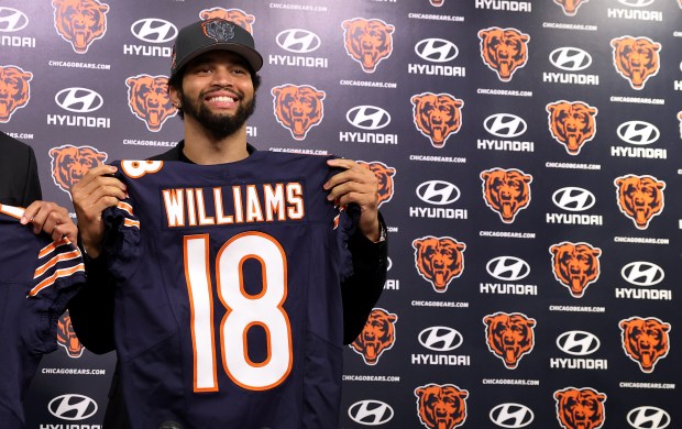 New Bears quarterback Caleb Williams poses for photographs at Halas Hall in Lake Forest on Friday, April 26, 2024. (Chris Sweda/Chicago Tribune)