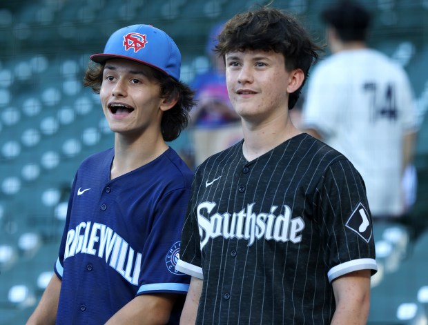 A Cubs fan and White Sox fan watches batting practice before a game between the Cubs and White Sox at Wrigley Field on June 5, 2024, in Chicago. (John J. Kim/Chicago Tribune)