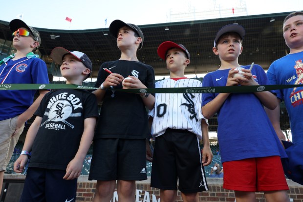 Youth Cubs and White Sox fans watche batting practice before a game between the Cubs and White Sox at Wrigley Field on June 5, 2024, in Chicago. (John J. Kim/Chicago Tribune)