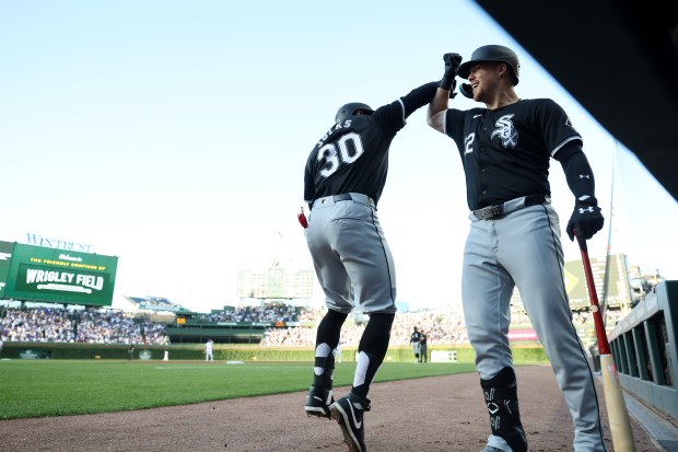 White Sox left fielder Corey Julks (30) and first baseman Gavin Sheets (32) celebrate after Julks hits a home run on the first pitch of the game against the Cubs at Wrigley Field on June 5, 2024, in Chicago. (John J. Kim/Chicago Tribune)