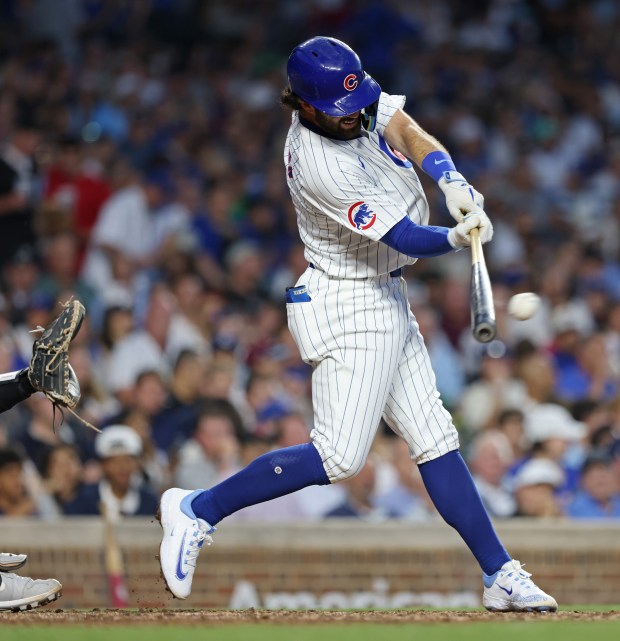 Cubs shortstop Dansby Swanson connects for a single in the fifth inning against the White Sox at Wrigley Field on June 5, 2024, in Chicago. (John J. Kim/Chicago Tribune)