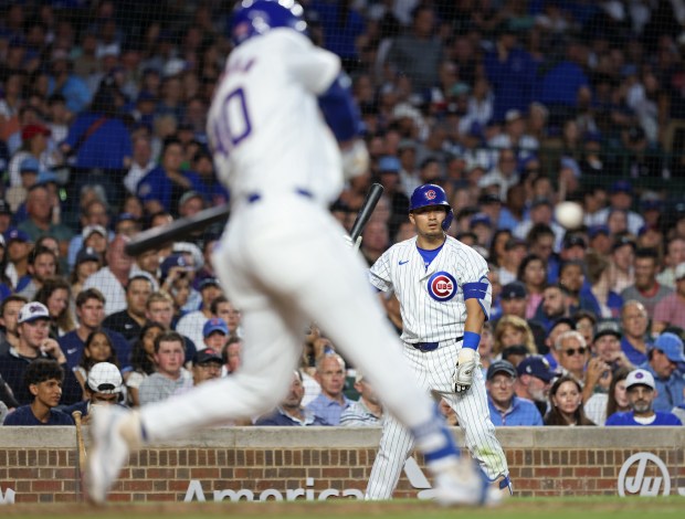 Cubs right fielder Seiya Suzuki, right, watches as Cubs designated hitter Mike Tauchman swings at the pitch in the fifth inning against the White Sox at Wrigley Field on June 5, 2024, in Chicago. (John J. Kim/Chicago Tribune)