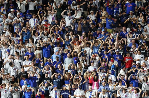 Fans sing and dance to "YMCA" during a White Sox pitching change in the seventh inning against the Cubs at Wrigley Field on June 5, 2024, in Chicago. (John J. Kim/Chicago Tribune)