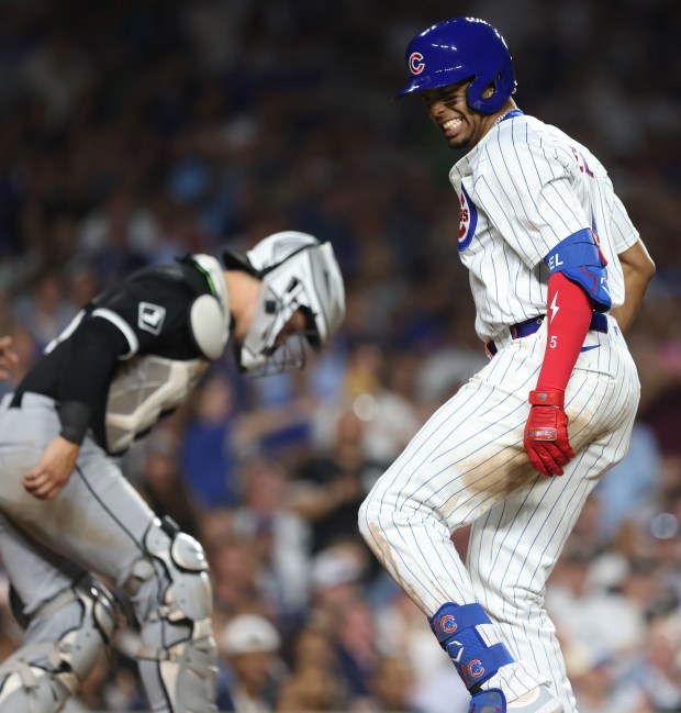 Cubs third baseman Christopher Morel, right, grimaces after hitting a ball off his left foot area in the seventh inning against the White Sox at Wrigley Field on June 5, 2024, in Chicago. (John J. Kim/Chicago Tribune)