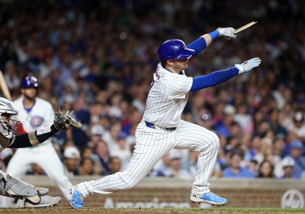 Cubs left fielder Ian Happ swings through on a broken bat RBI single in the seventh inning against the White Sox at Wrigley Field on June 5, 2024, in Chicago. (John J. Kim/Chicago Tribune)