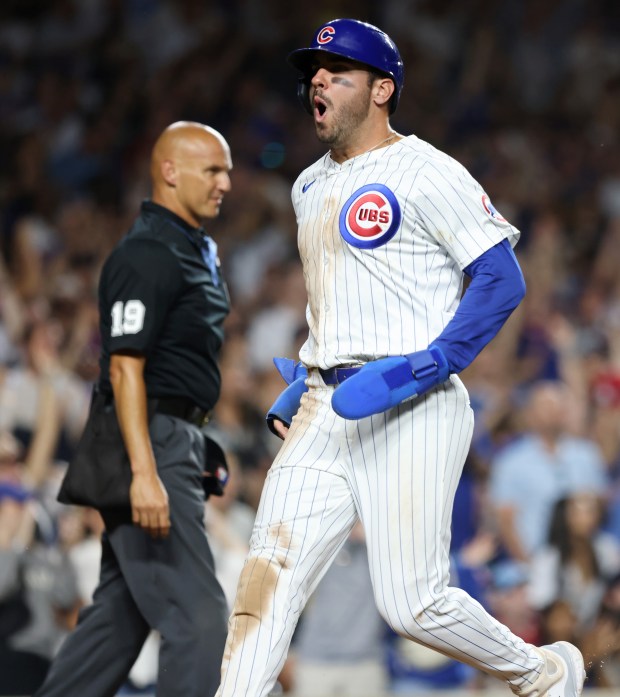 Cubs designated hitter Mike Tauchman celebrates after scoring off an RBI single from left fielder Ian Happ in the seventh inning against the White Sox at Wrigley Field on June 5, 2024, in Chicago. (John J. Kim/Chicago Tribune)