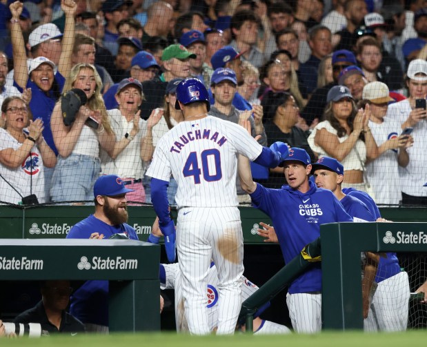 Cubs manager Craig Counsell, center right, congratulates designated hitter Mike Tauchman after scoring off an RBI single from left fielder Ian Happ in the seventh inning against the White Sox at Wrigley Field on June 5, 2024, in Chicago. (John J. Kim/Chicago Tribune)