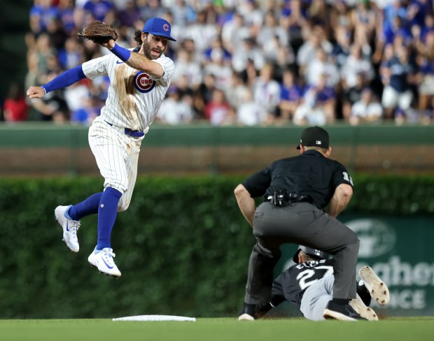 White Sox pinch runner Duke Ellis (27) beats the tag from Cubs shortstop Dansby Swanson (7) to steal second base in the ninth inning at Wrigley Field on June 5, 2024, in Chicago. (John J. Kim/Chicago Tribune)