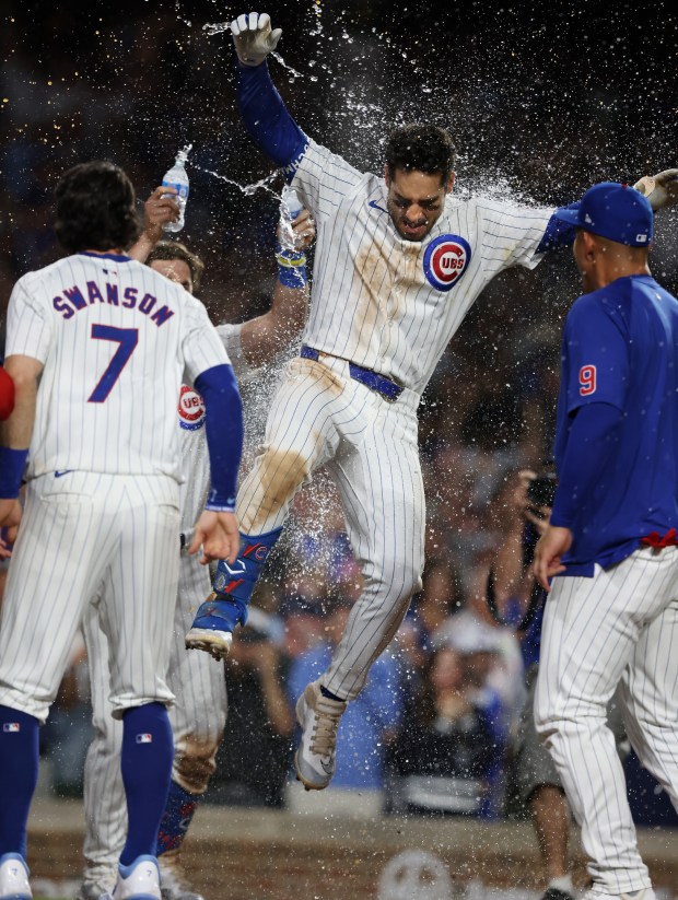 Cubs designated hitter Mike Tauchman leaps onto the plate after hitting a walk-off home run for a 7-6 win over the White Sox at Wrigley Field on June 5, 2024, in Chicago. (John J. Kim/Chicago Tribune)