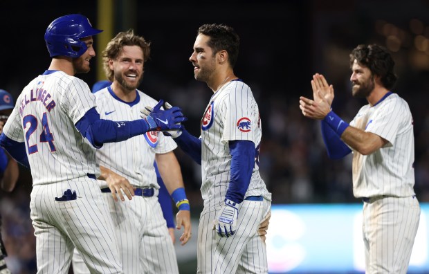 Cubs designated hitter Mike Tauchman, center, is congratulated by teammates after hitting a walk-off home run for a 7-6 win over the White Sox at Wrigley Field on June 5, 2024, in Chicago. (John J. Kim/Chicago Tribune)