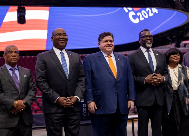 Ald. Walter Burnett, 27th, left, DNC chair Jaime Harrison, Gov. J.B. Pritzker, Mayor Brandon Johnson and convention chair Minyon Moore arrive to speak during a walkthrough of the Democratic National Convention on May 22, 2024, at the United Center. (Brian Cassella/Chicago Tribune)