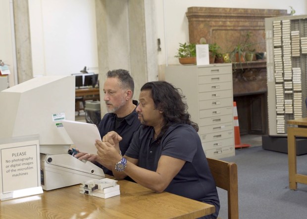 Professor Vivek Bald, left, and Alaudin Ullah check the archives for documentation of Bengali "shipjumpers," including Ullah's restauranteur father Habib Ullah. The pair co-directed a documentary, "In Search of Bengali Harlem." (Bengali Harlem Productions)