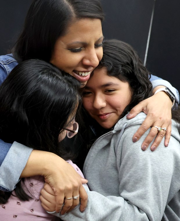 Rachael Mahmood is embraced by her fifth grade students after winning Illinois Teacher of the Year at Georgetown Elementary School on May 2, 2024, in Aurora. Mahmood, who has been teaching for 20 years, was selected from among 13 finalists across Illinois. (Stacey Wescott/Chicago Tribune)