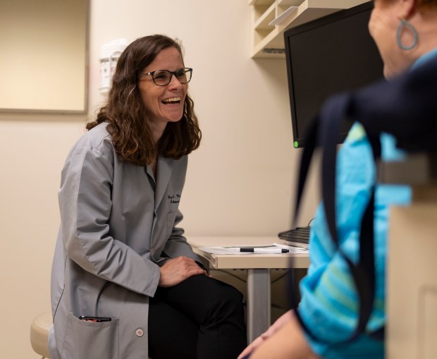 Dr. Mary Mulcahey speaks with patient Mary Pat Larocca about her knee during an appointment, May 30, 2024, at Loyola Medicine in Maywood. (Brian Cassella/Chicago Tribune)