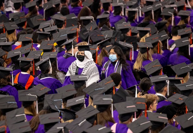 Several dozen graduates silently walk out in support of the Palestinians during Northwestern University's commencement on June 9, 2024, at the United Center. (Brian Cassella/Chicago Tribune)