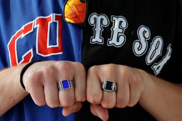 Eric Georgis shows off his colored rings and homemade half-Cubs half-White Sox jersey at on May 23, 2024. Georgis and his friends attended both Cubs and White Sox home games on Thursday, using the CTA Red Line train to travel between Wrigley Field and Guaranteed Rate Field. (Chris Sweda/Chicago Tribune)