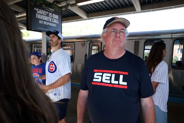 Chicago White Sox fan Russ Frankowski, left, and his son, Steven Frankowski, not pictured, wait at the Addison Red Line station after attending the Cubs-Braves game in Chicago on May 23, 2024. Following the train ride south, the two then attended the Sox-Orioles game that started at 6:40 p.m. (Chris Sweda/Chicago Tribune)