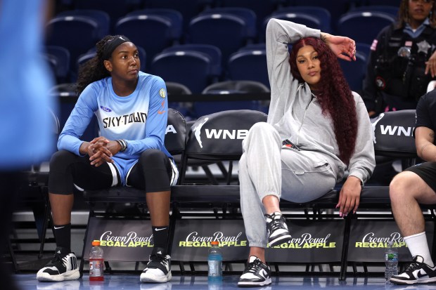 Chicago Sky center Elizabeth Williams (left) and injured center Kamilla Cardoso (right) relax on the bench as players warm up for the Sky's home opener against the Connecticut Sun at Wintrust Arena in Chicago on May 25, 2024. (Chris Sweda/Chicago Tribune)