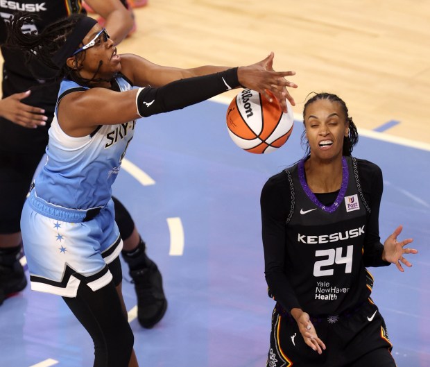 Chicago Sky guard Diamond DeShields (0) tries to regain control of the ball in front of Connecticut Sun forward DeWanna Bonner (24) in the first half of the Sky's home opener at Wintrust Arena in Chicago on May 25, 2024. (Chris Sweda/Chicago Tribune)