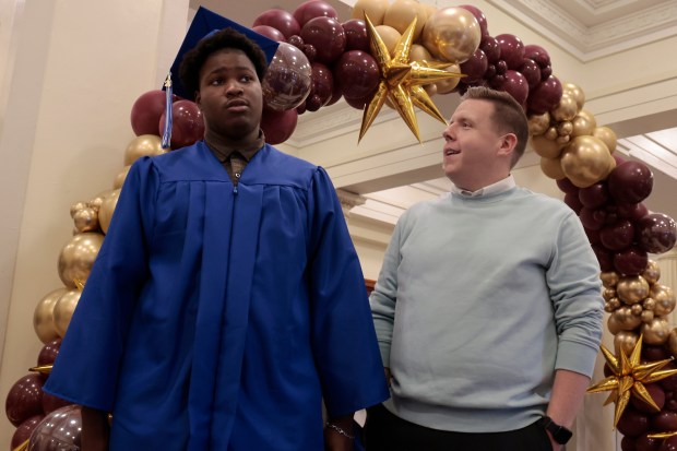 Southside Occupational Academy graduate Elijah Winston listens to hi special education teacher Jim McGuire before the start of the graduation ceremony at Lindbloom Math and Science Academy on May 29, 2024, in Chicago. (Antonio Perez/Chicago Tribune)