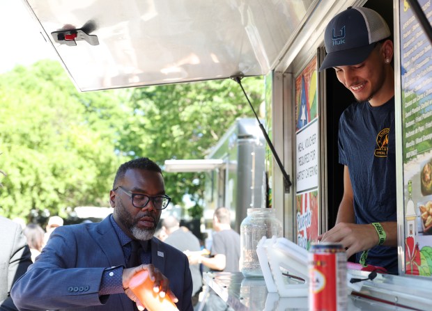 Mayor Brandon Johnson gets a snack from a food truck while attending the Sueños Music Festival at Grant Park Saturday, May 25, 2024, in Chicago. (John J. Kim/Chicago Tribune)