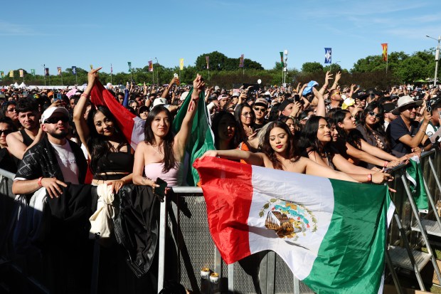 Concertgoers hold a Mexican flag as Bizarrap performs during the Sueños Music Festival at Grant Park on May 25, 2024, in Chicago. (John J. Kim/Chicago Tribune)