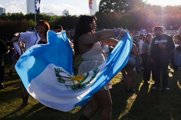 Zulema Argueta dances with a Guatemalan flag during the Sueños Festival at Grant Park on May 26, 2024. (Eileen T. Meslar/Chicago Tribune)