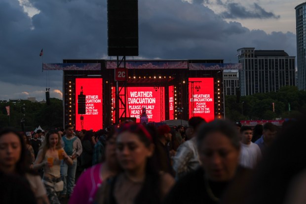 Festival goers exit Grant Park as Sueños Festival was cut short due to inclement weather on May 26, 2024. (Eileen T. Meslar/Chicago Tribune)