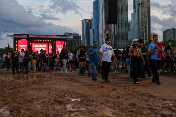 Festival goers exit Grant Park as Sueños Festival was cut short due to inclement weather on May 26, 2024. (Eileen T. Meslar/Chicago Tribune)