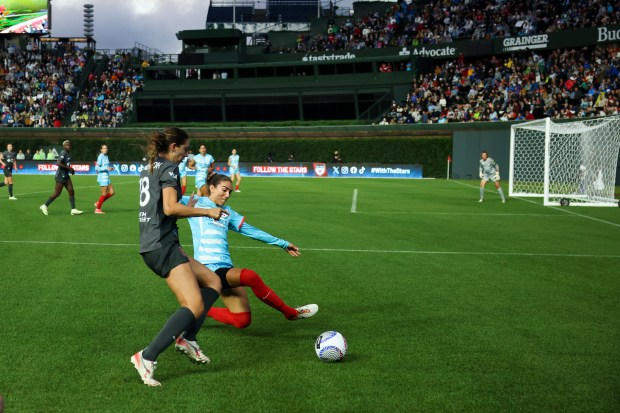 Chicago Red Stars defender Tatumn Milazzo (23) tackles Bay FC's Joelle Anderson during their game at Wrigley Field. (Eileen T. Meslar/Chicago Tribune)