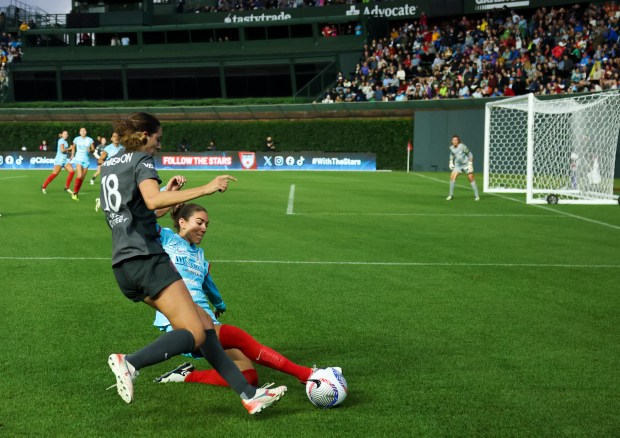 Chicago Red Stars defender Tatumn Milazzo (23) tackles Bay FC's Joelle Anderson during their game at Wrigley Field. (Eileen T. Meslar/Chicago Tribune)