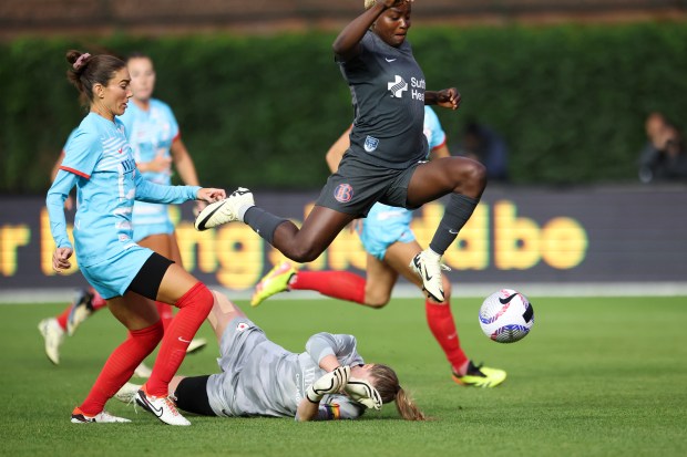 Chicago Red Stars defender Tatumn Milazzo (23) tries to catch up to Bay FC's Racheal Kundananji as she jumps over Chicago Red Stars goalkeeper Alyssa Naeher (1) during their game at Wrigley Field on June 8, 2024. (Eileen T. Meslar/Chicago Tribune)