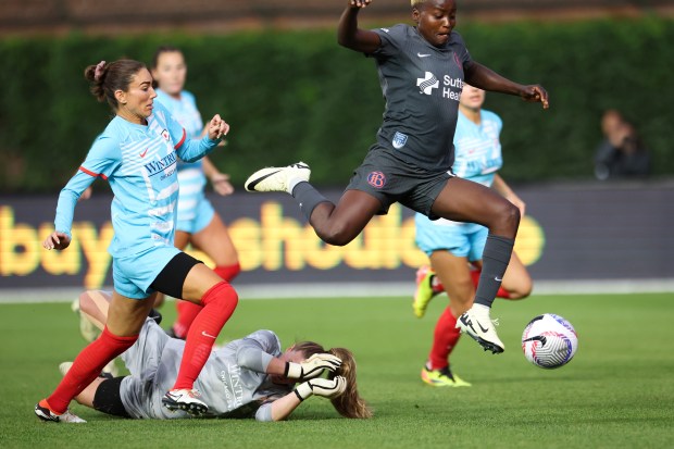 Chicago Red Stars defender Tatumn Milazzo (23) tries to catch up to Bay FC's Racheal Kundananji as she jumps over Chicago Red Stars goalkeeper Alyssa Naeher (1) during their game at Wrigley Field on June 8, 2024. (Eileen T. Meslar/Chicago Tribune)