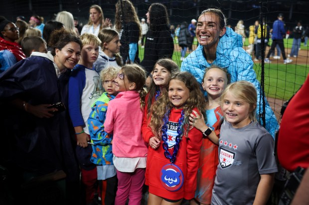 Chicago Red Stars defender Tatumn Milazzo poses with fans after the Chicago Red Stars hosted Bay FC for a game at Wrigley Field on June 8, 2024. (Eileen T. Meslar/Chicago Tribune)