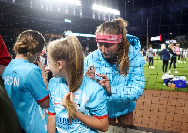 Chicago Red Stars forward Ally Schlegel signs a jersey after the Chicago Red Stars hosted Bay FC for a game at Wrigley Field on June 8, 2024. (Eileen T. Meslar/Chicago Tribune)