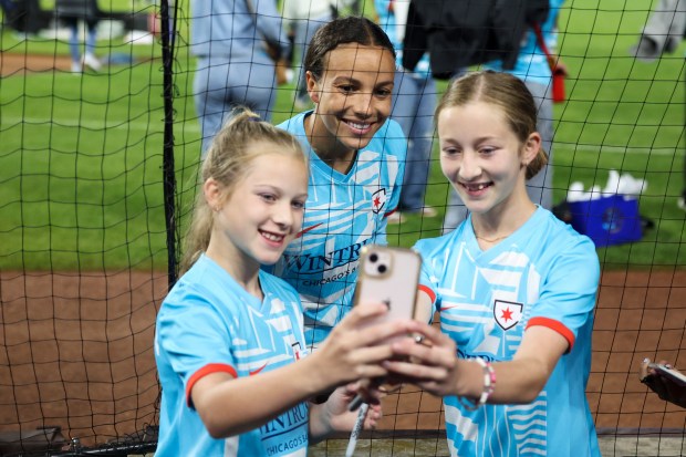 Zoey and Lilyan Handley pose with Chicago Red Stars forward Mallory Swanson after the Chicago Red Stars hosted Bay FC for a game at Wrigley Field on June 8, 2024. (Eileen T. Meslar/Chicago Tribune)