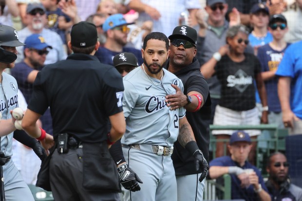 Tommy Pham of the White Sox is restrained by coaches during the eighth inning against the Brewers on June 2, 2024, in Milwaukee. (Stacy Revere/Getty Images)