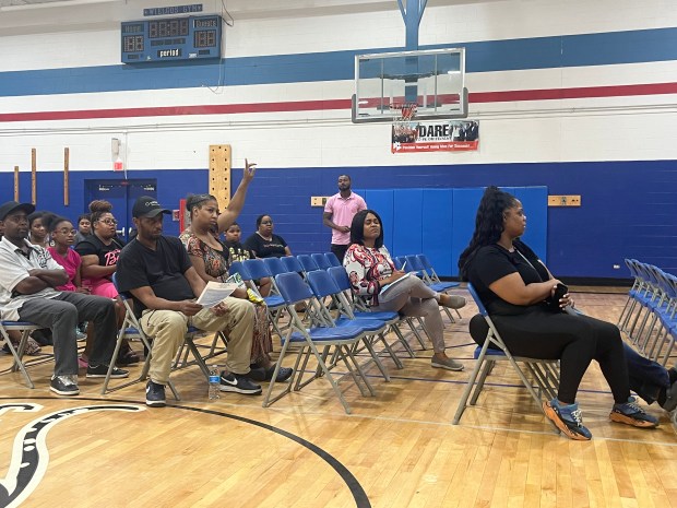 Mashantala Kidd, who has a son in Dolton Elementary District 149, raises her hand during a town hall meeting on school renovations June 5, 2024. (Olivia Stevens/Daily Southtown)