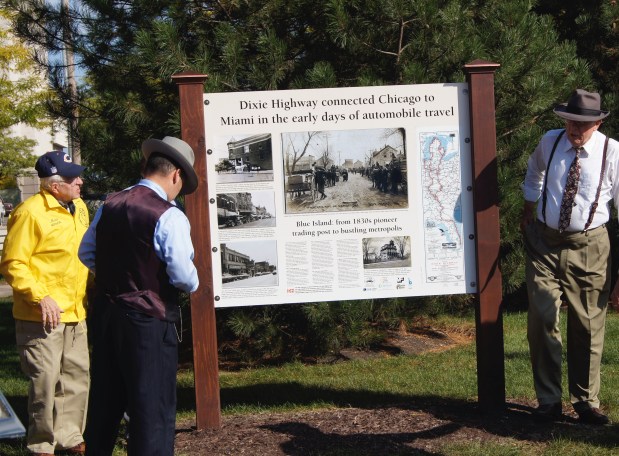 Members of the A's R Us Model A Ford club erect new storyboard signs along the Dixie Highway in 2015, the 100th anniversary of the historic highway. (Phil Serviss)