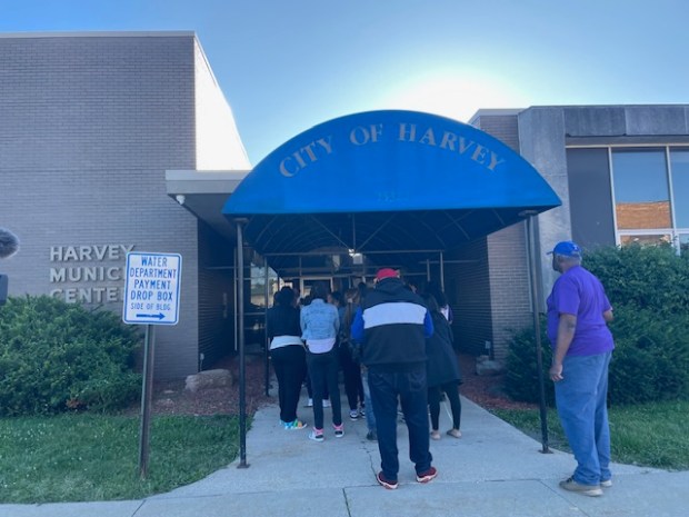 Protesters wait to enter the Harvey municipal building before Monday's City Council meeting. (Samantha Moilanen/Daily Southtown)