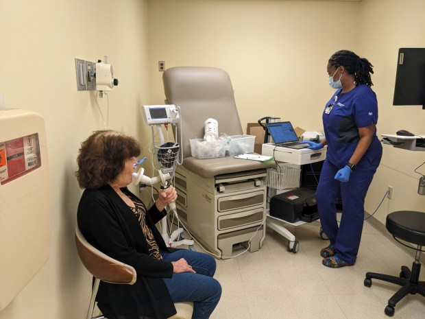 Michelle Knight, of Oak Forest, receives a spirometry test to measure her lung capacity from respiratory therapist Marilyn Ray during a recent visit to Northwestern Medicine Palos Hospital's new Lung Transplant Clinic in Palos Heights as part of her recovery from a double lung transplant. (Janice Neumann/Daily Southtown)